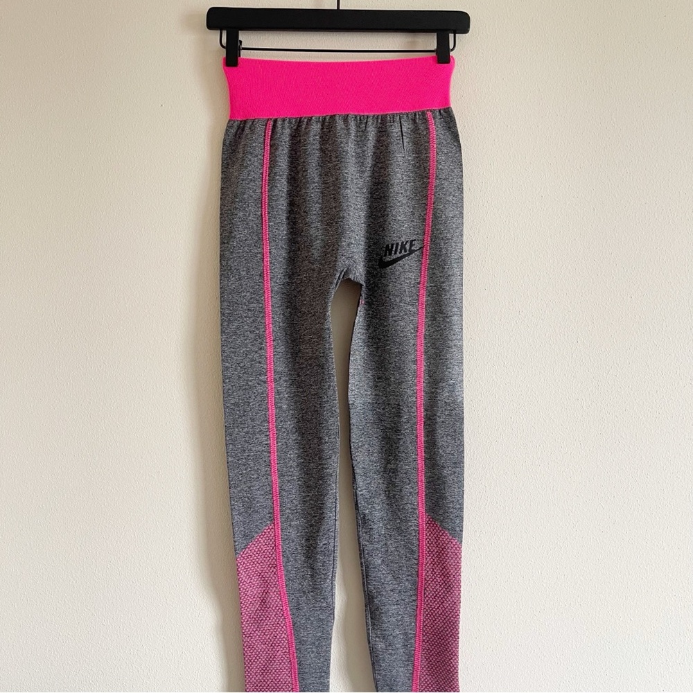 Nike leggings showcase a sleek gray base with vibrant pink accents size small